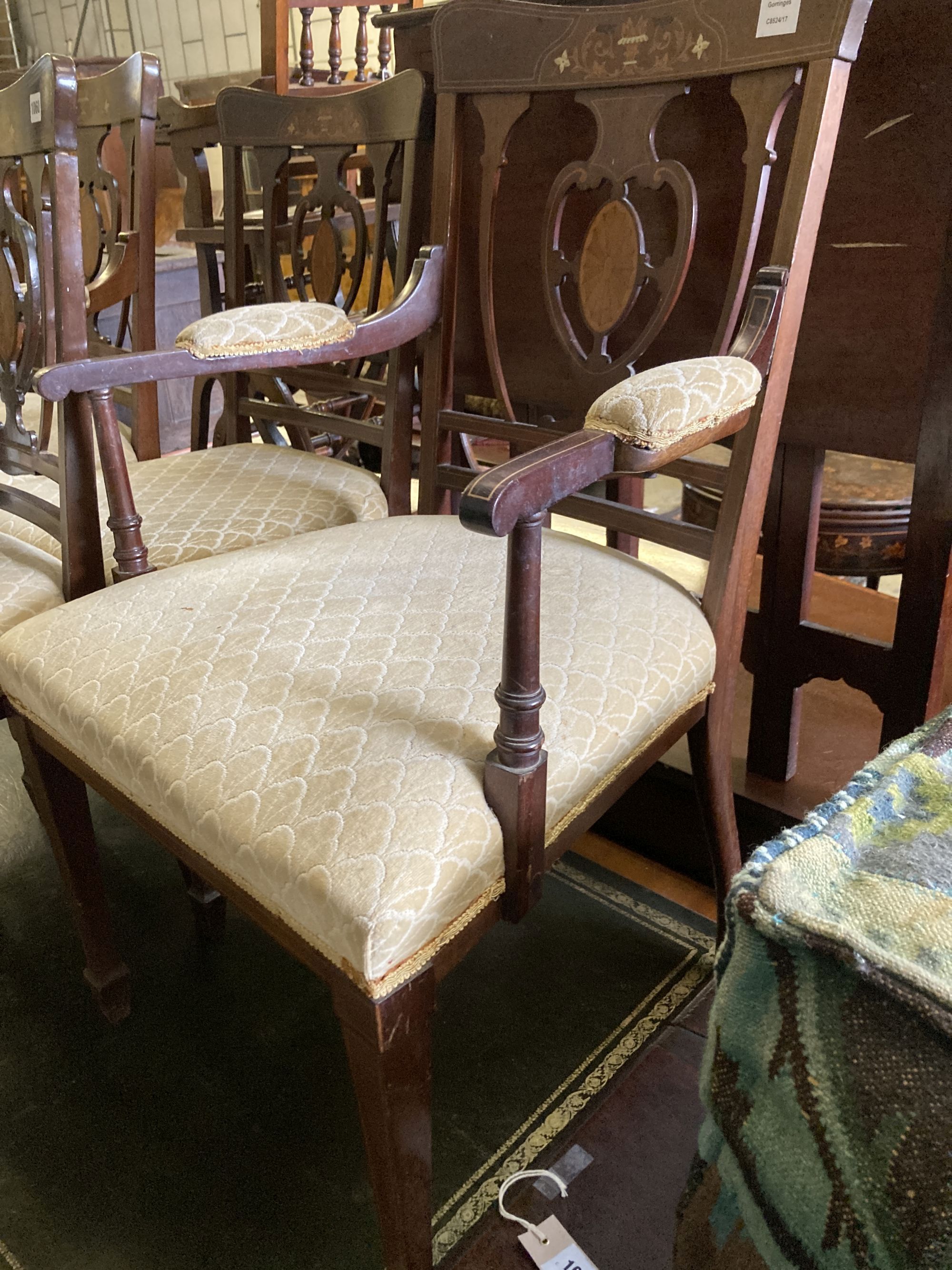 A pair of Edwardian inlaid mahogany elbow chairs and a matching single chair (3)